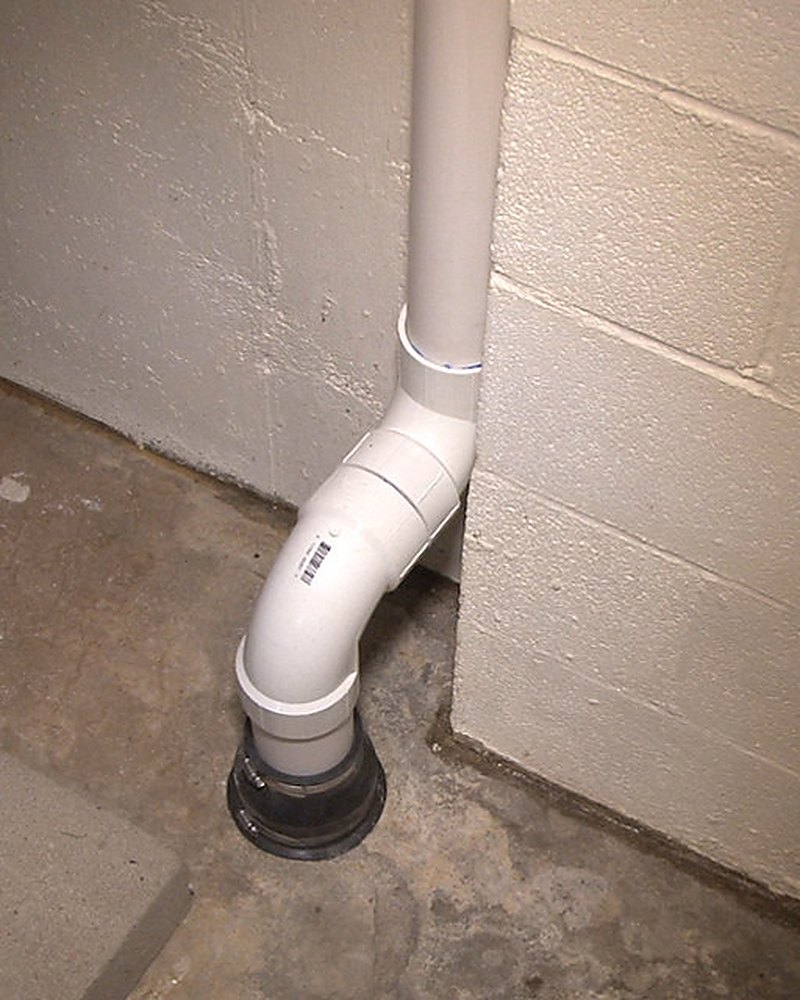 Interior radon suction point piped through a Pennington County basement slab